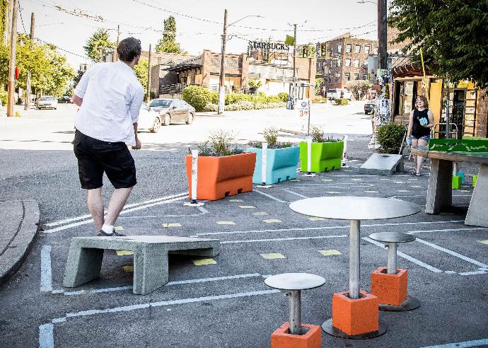 Concrete cornhole game Guy playing concrete cornhole in the park