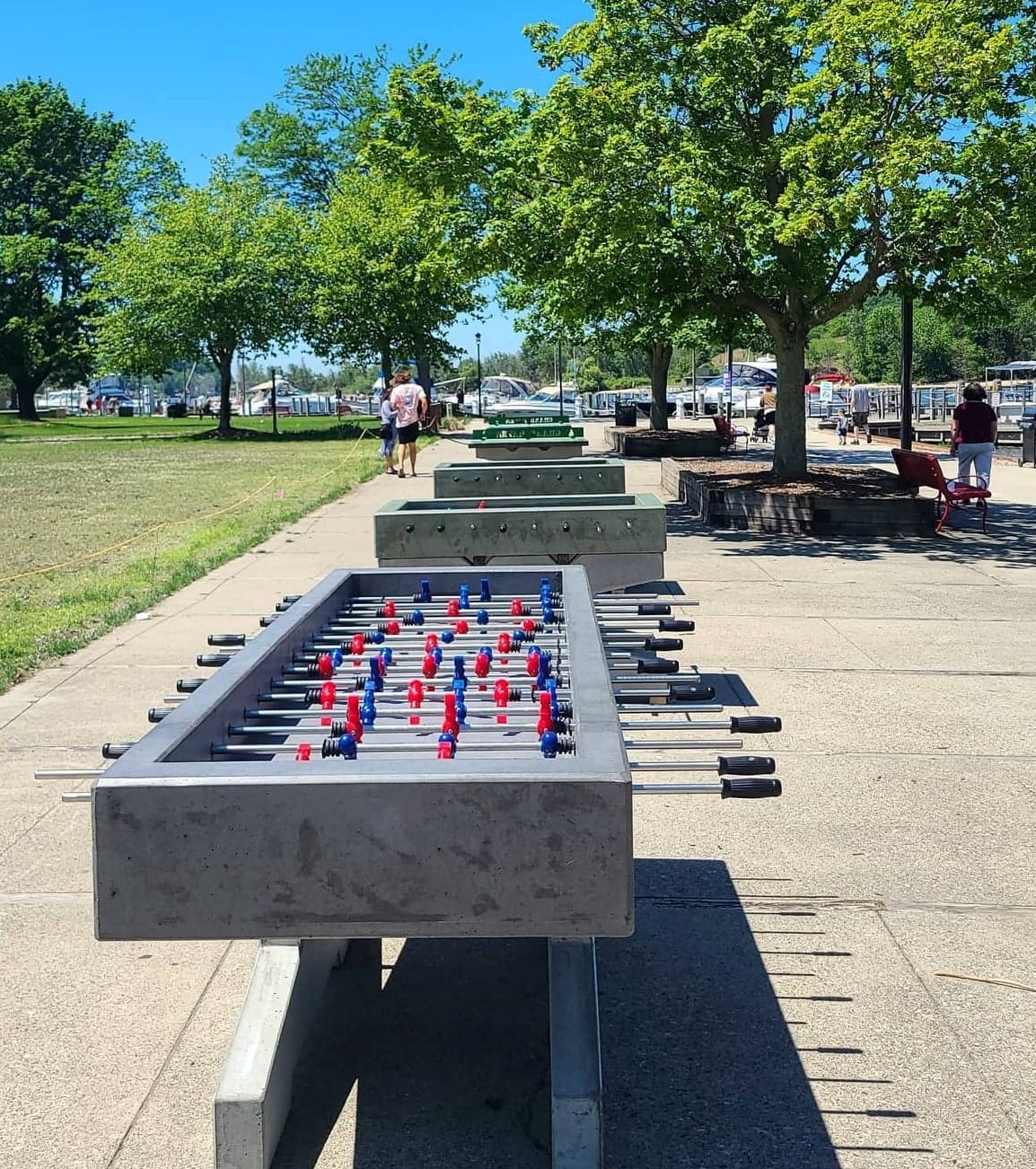 Double Foosball Table in the park with standard concrete cornhole boards