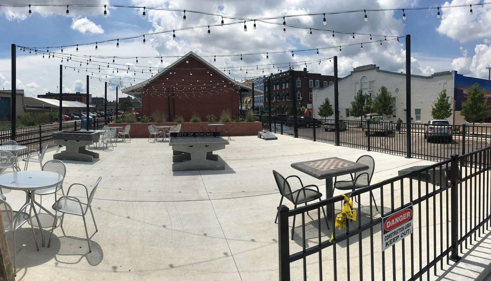 Outdoor area with concrete games including pingpong cornhole foosball and chess Outdoor area with concrete games including pingpong cornhole foosball and chess