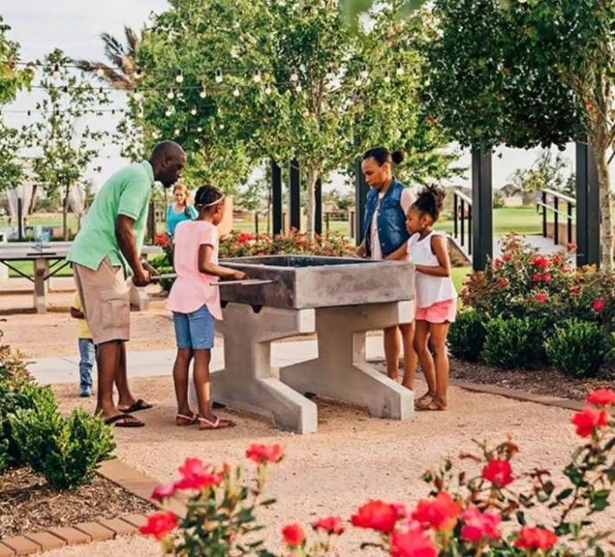 Concrete Foosball Table in a park Family playing on concrete foosball table at the park