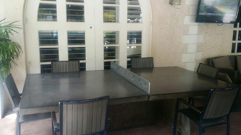 Concrete ping pong dining table on villa patio