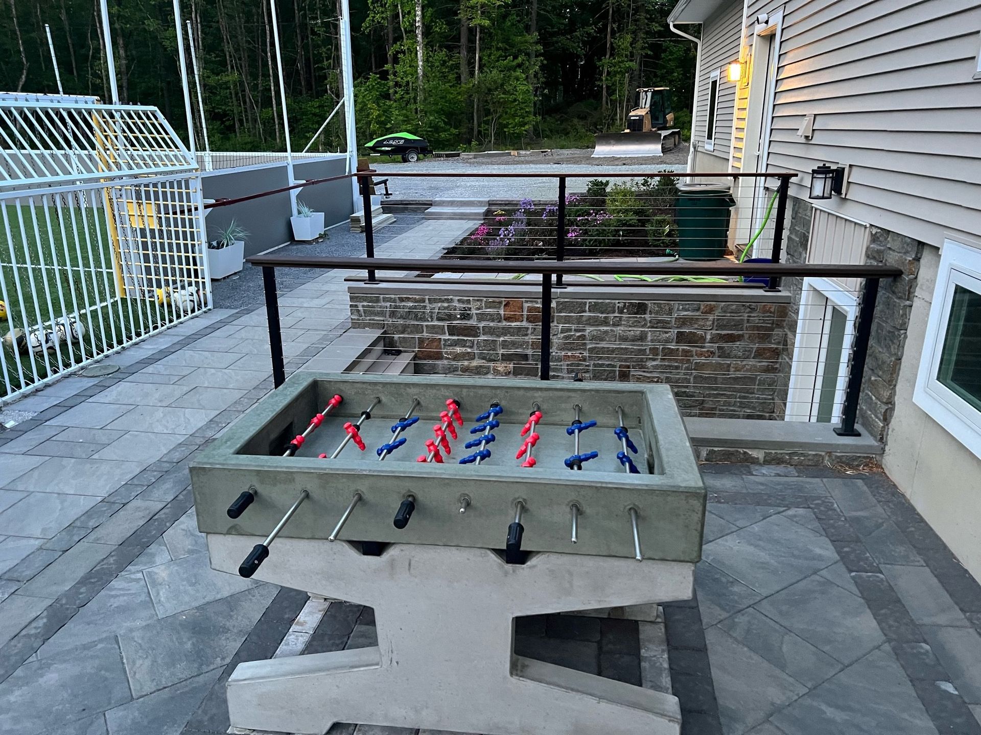 Concrete foosball table in a very playful back yard