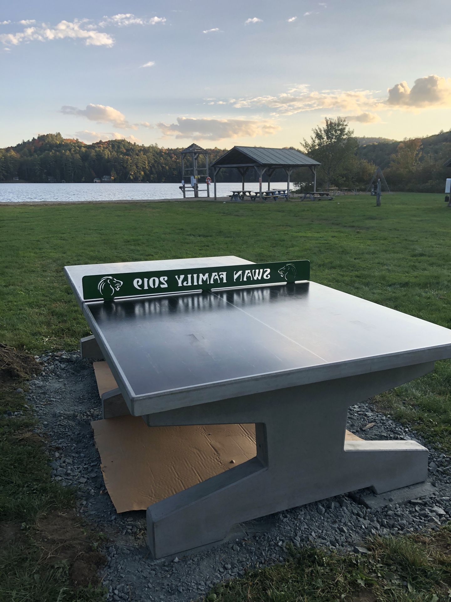 Lakefront yard with concrete ping pong table