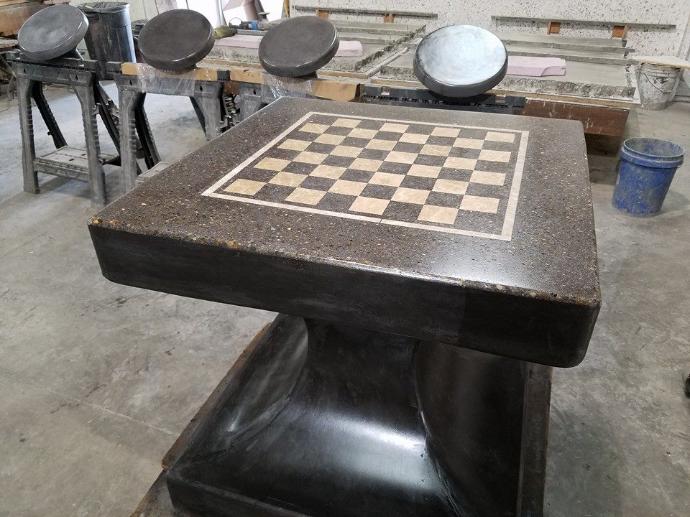 Batman-themed custom concrete chess table with built-in chessboard for outdoor use