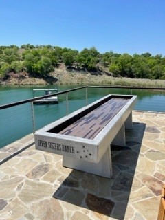 Outdoor concrete shuffleboard table installed at resort or park recreation area