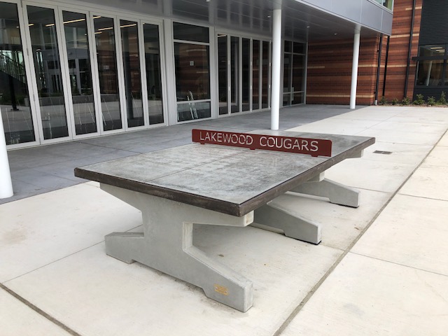 Outdoor concrete ping pong table installation at public park or community space